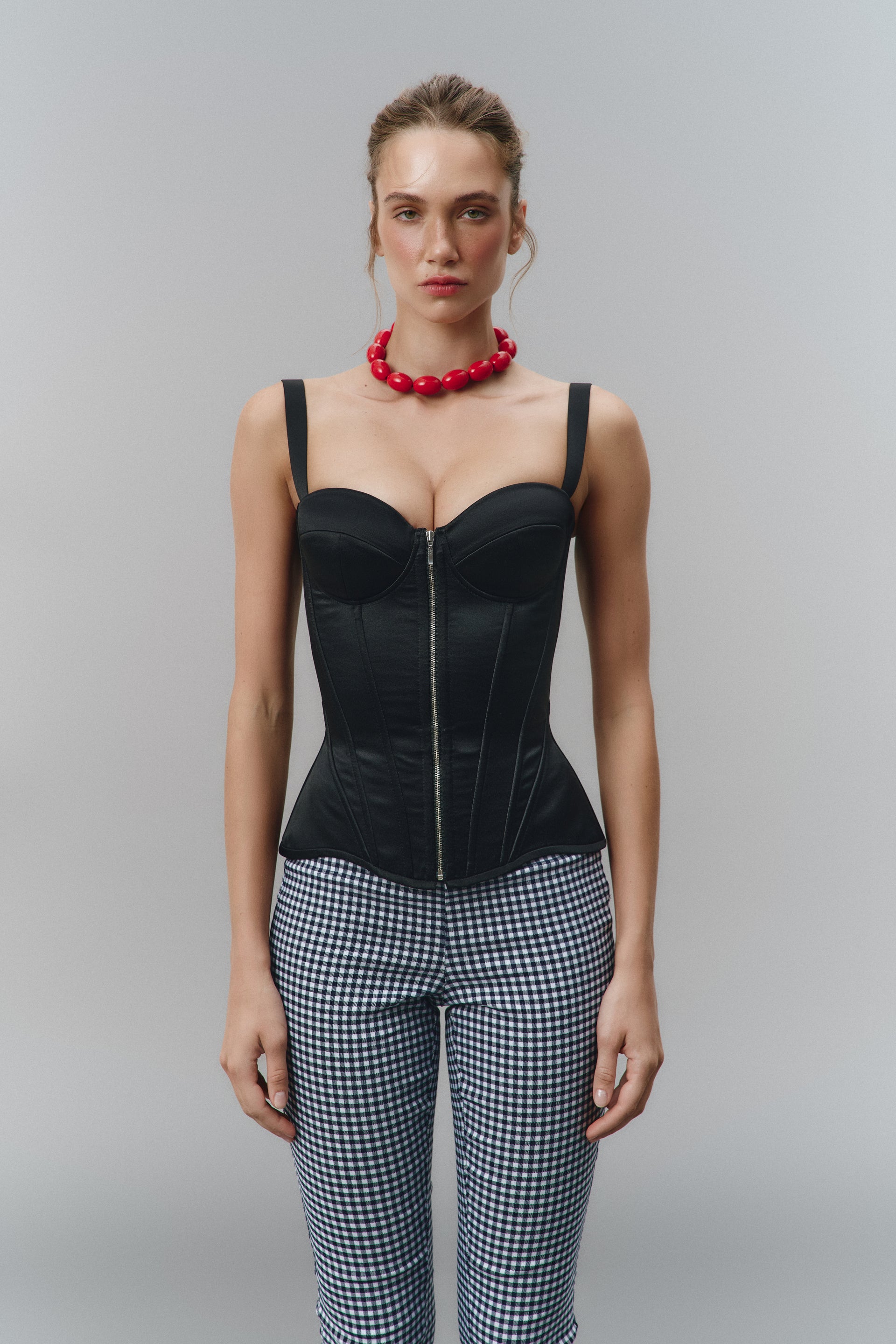 Defiance drop. A black corset with removable straps and a zipper
